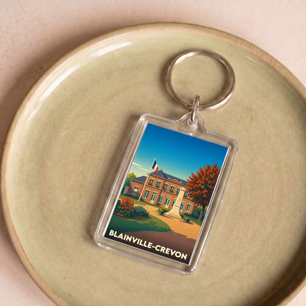 Porte-clés souvenir de la ville de Blainville-Crevon avec une illustration stylisée de sa mairie.