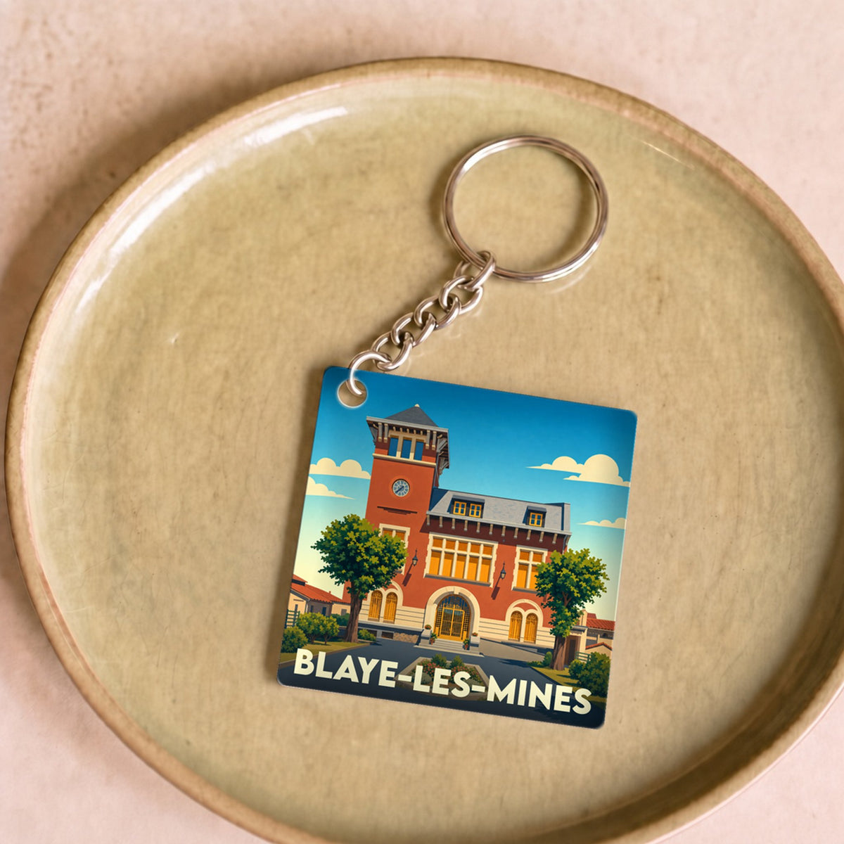 Porte-clés souvenir de la ville de Blaye-les-Mines avec une illustration stylisée de sa mairie.