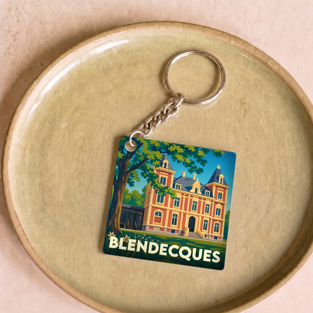 Porte-clés souvenir de la ville de Blendecques avec une illustration stylisée d'un château.