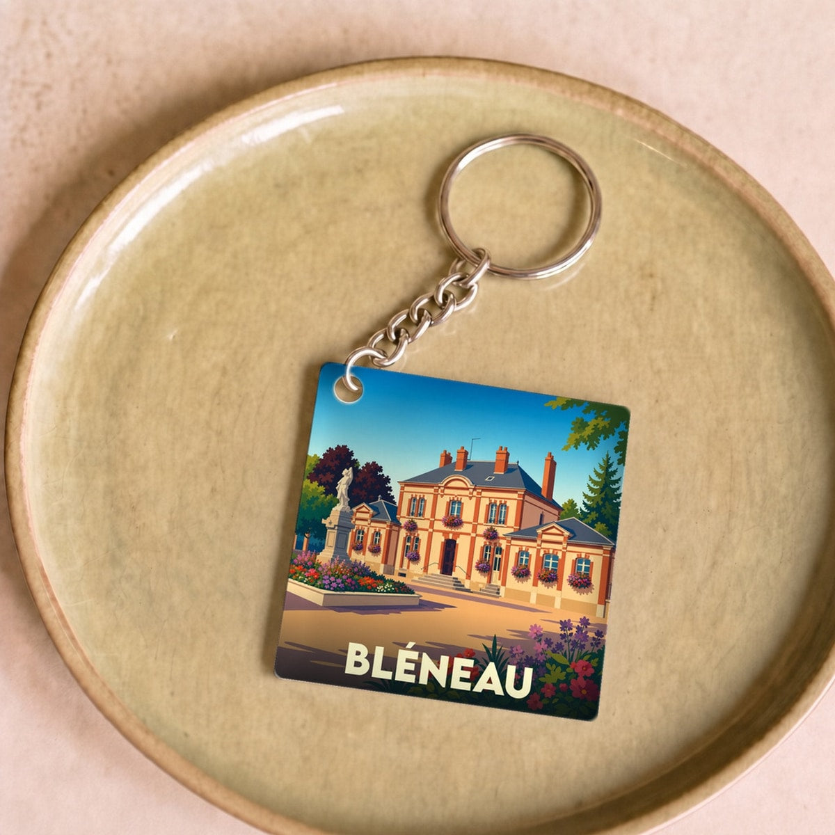 Porte-clés souvenir de la ville de Bléneau avec une illustration stylisée.