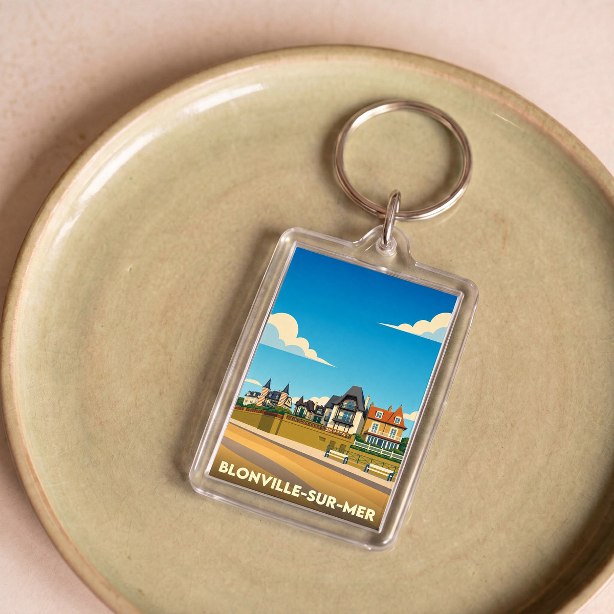 Porte-clés souvenir de la ville de Blonville-sur-Mer avec une illustration stylisée de son front de mer.