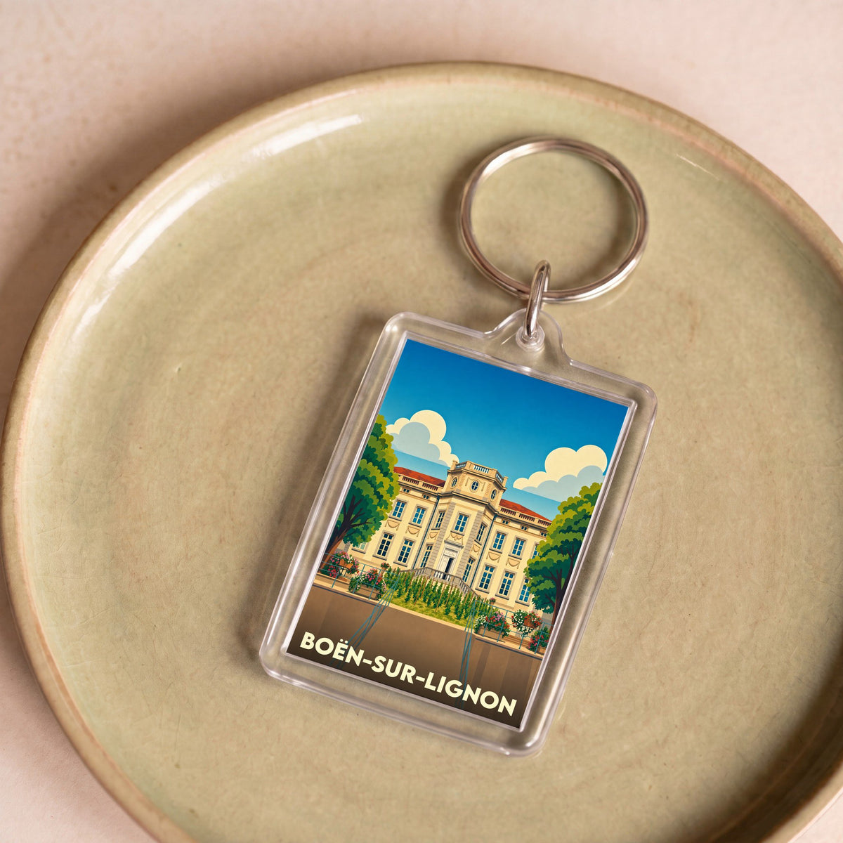 Porte-clés souvenir de la ville de Boën-sur-Lignon avec une illustration stylisée.