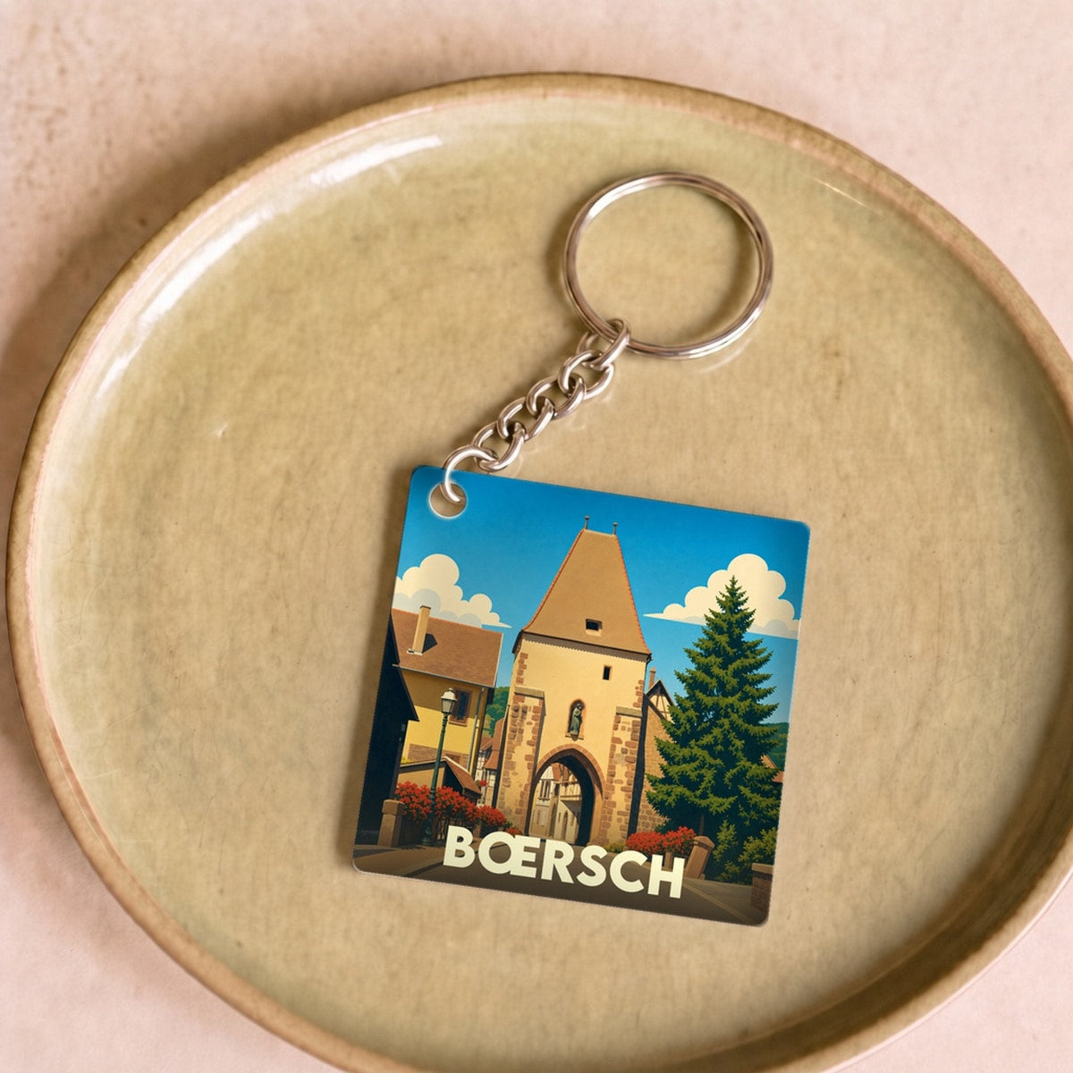 Porte-clés souvenir de la ville de Bœrsch avec une illustration stylisée de sa porte fortifiée.
