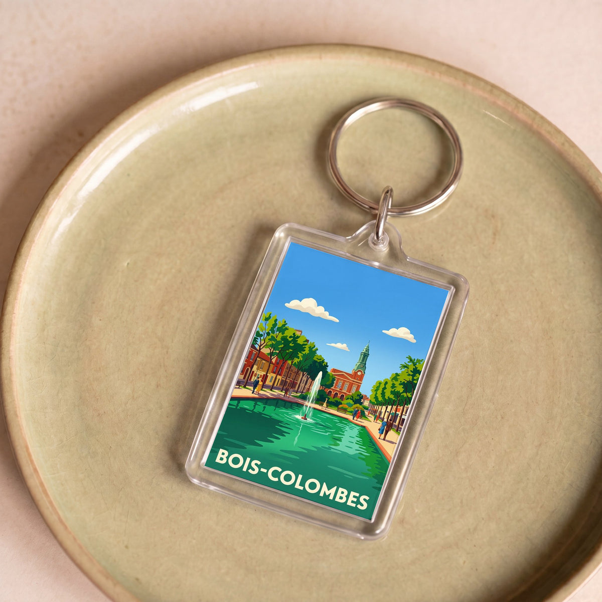 Porte-clés souvenir de la ville de Bois-Colombes avec une illustration stylisée.