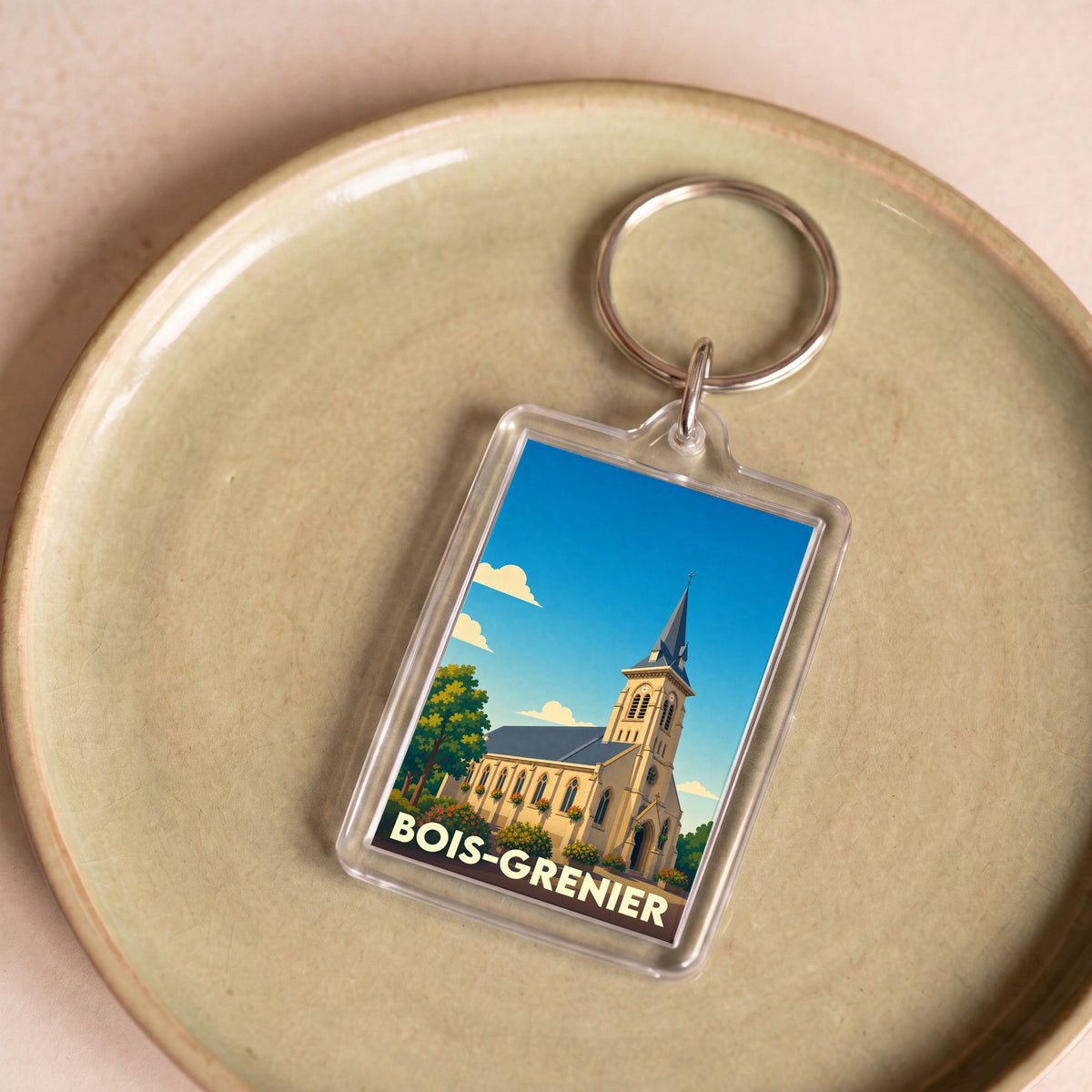 Porte-clés souvenir de la ville de Bois-Grenier avec une illustration stylisée de son église.