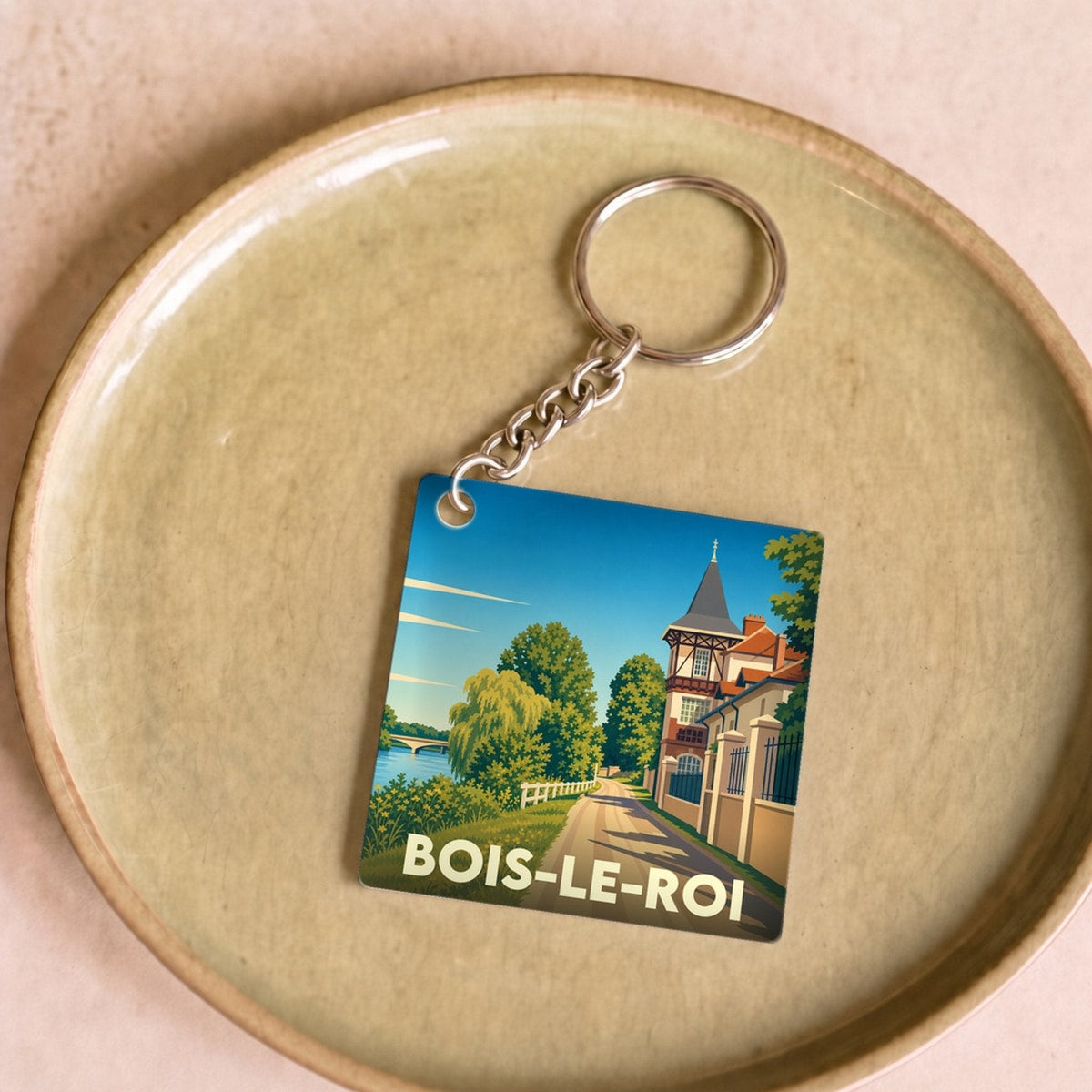 Porte-clés souvenir de la ville de Bois-le-Roi avec une illustration stylisée.