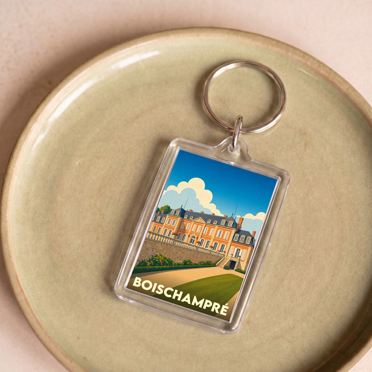 Porte-clés souvenir de la ville de Boischampré avec une illustration stylisée du château.