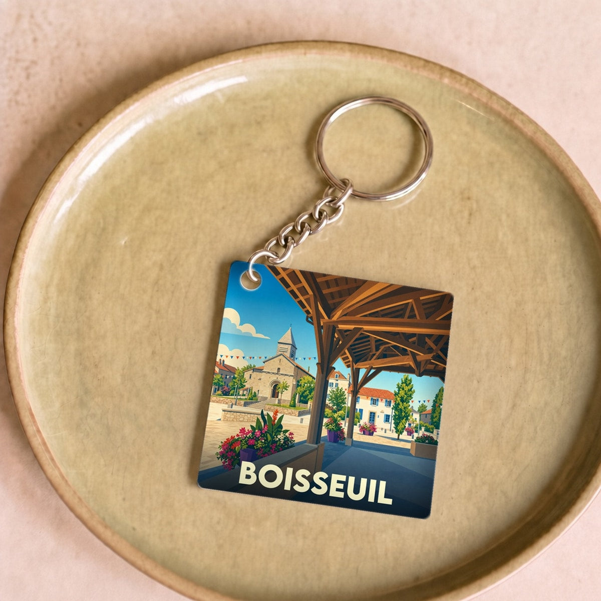Porte-clés souvenir de la ville de Boisseuil avec une illustration stylisée.