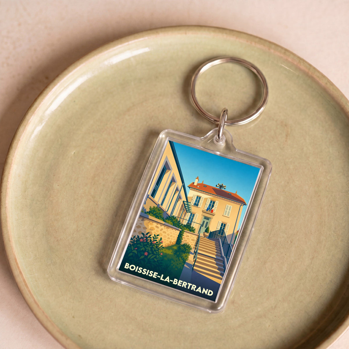 Porte-clés souvenir de la ville de Boissise-la-Bertrand avec une illustration stylisée.
