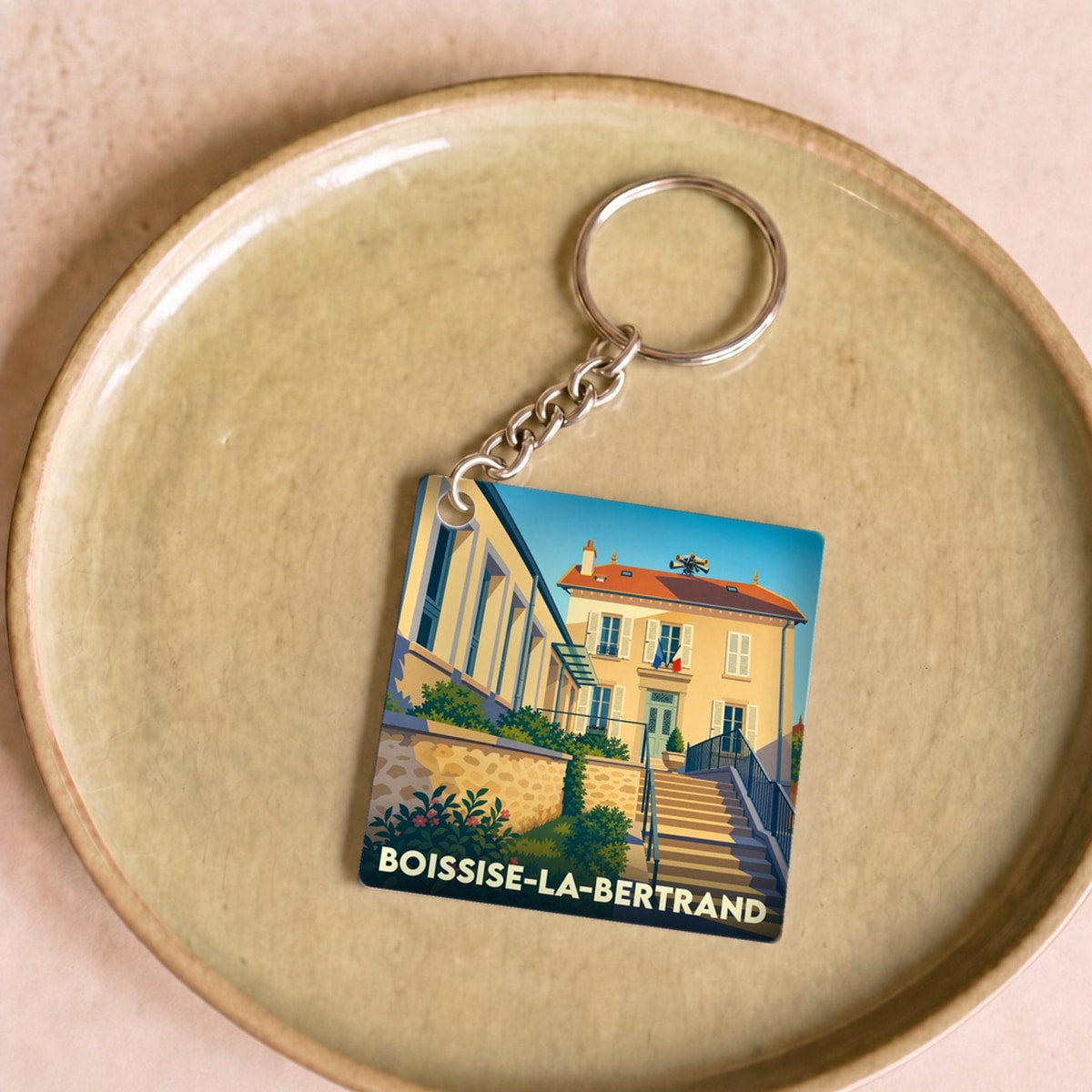 Porte-clés souvenir de la ville de Boissise-la-Bertrand avec une illustration stylisée.