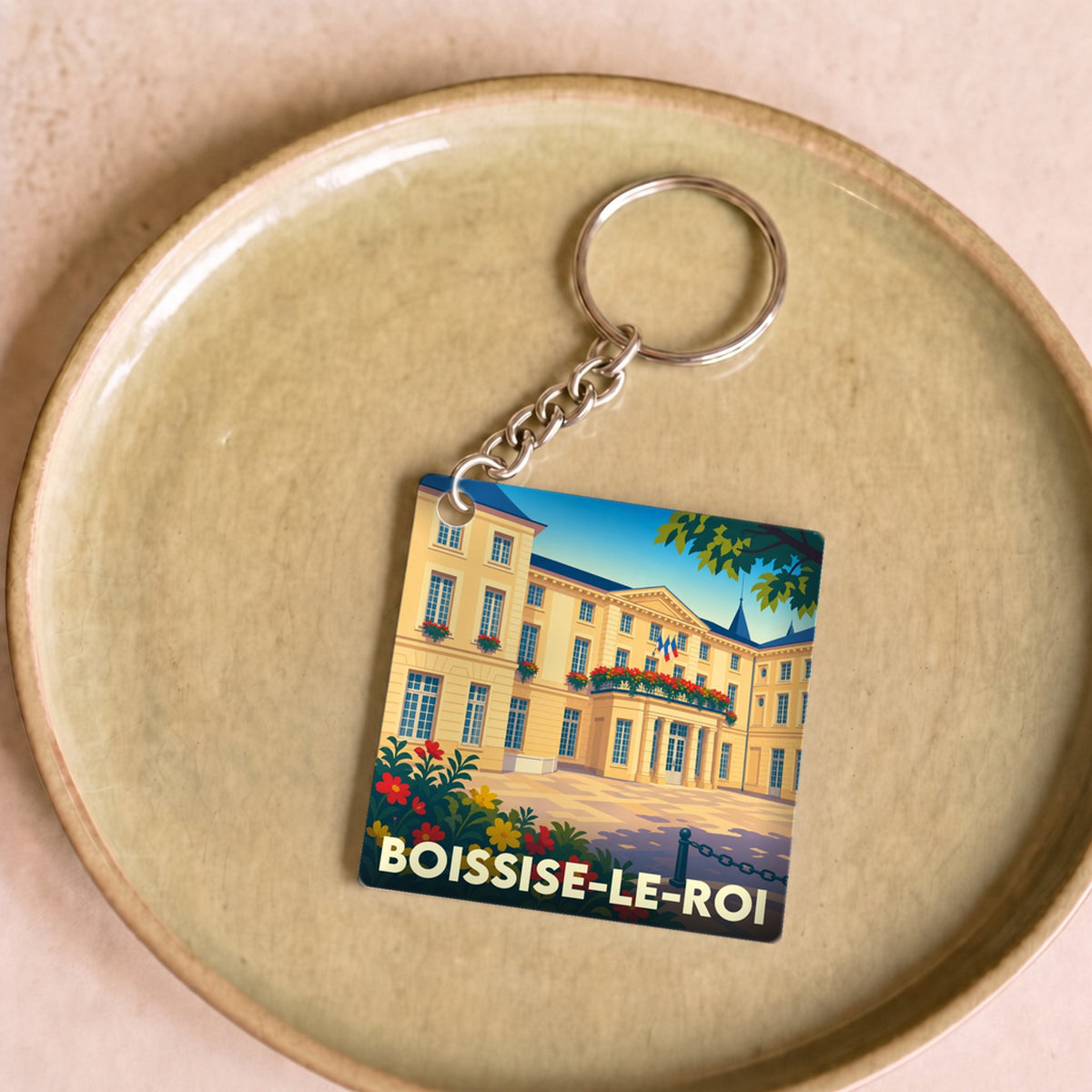 Porte-clés souvenir de la ville de Boissise-le-Roi avec une illustration stylisée.