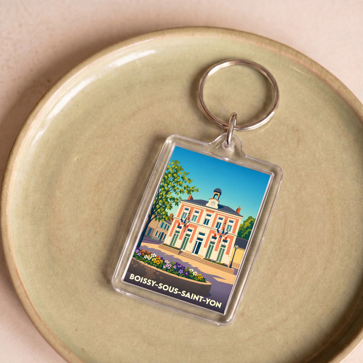Porte-clés souvenir de la ville de Boissy-sous-Saint-Yon avec une illustration stylisée de sa mairie.