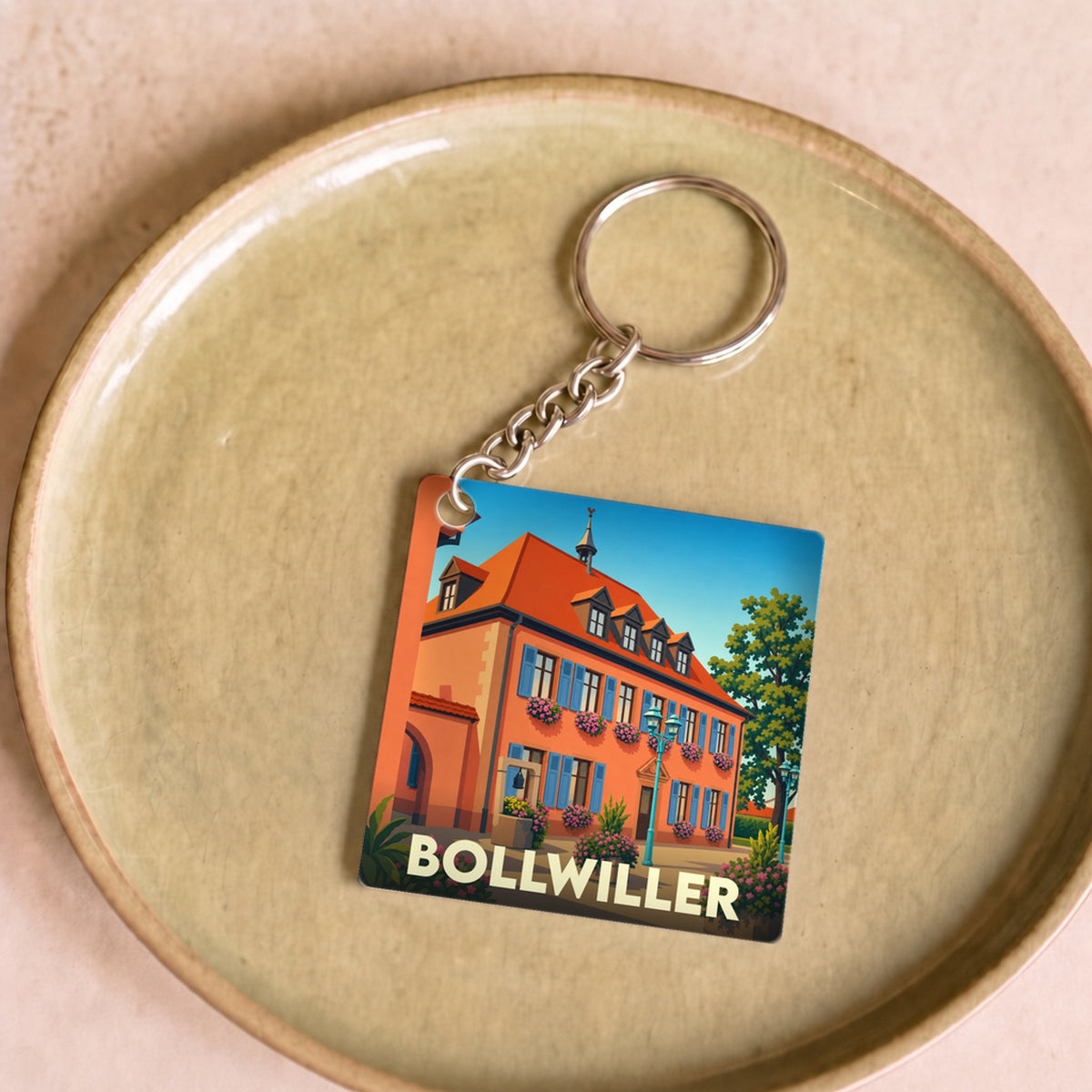Porte-clés souvenir de la ville de Bollwiller avec une illustration stylisée.