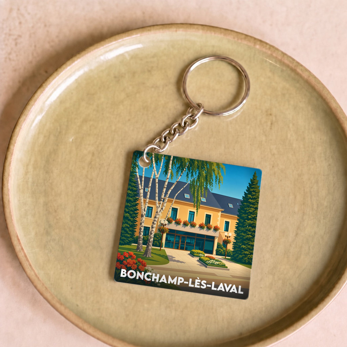 Porte-clés souvenir de la ville de Bonchamp-lès-Laval avec une illustration stylisée.