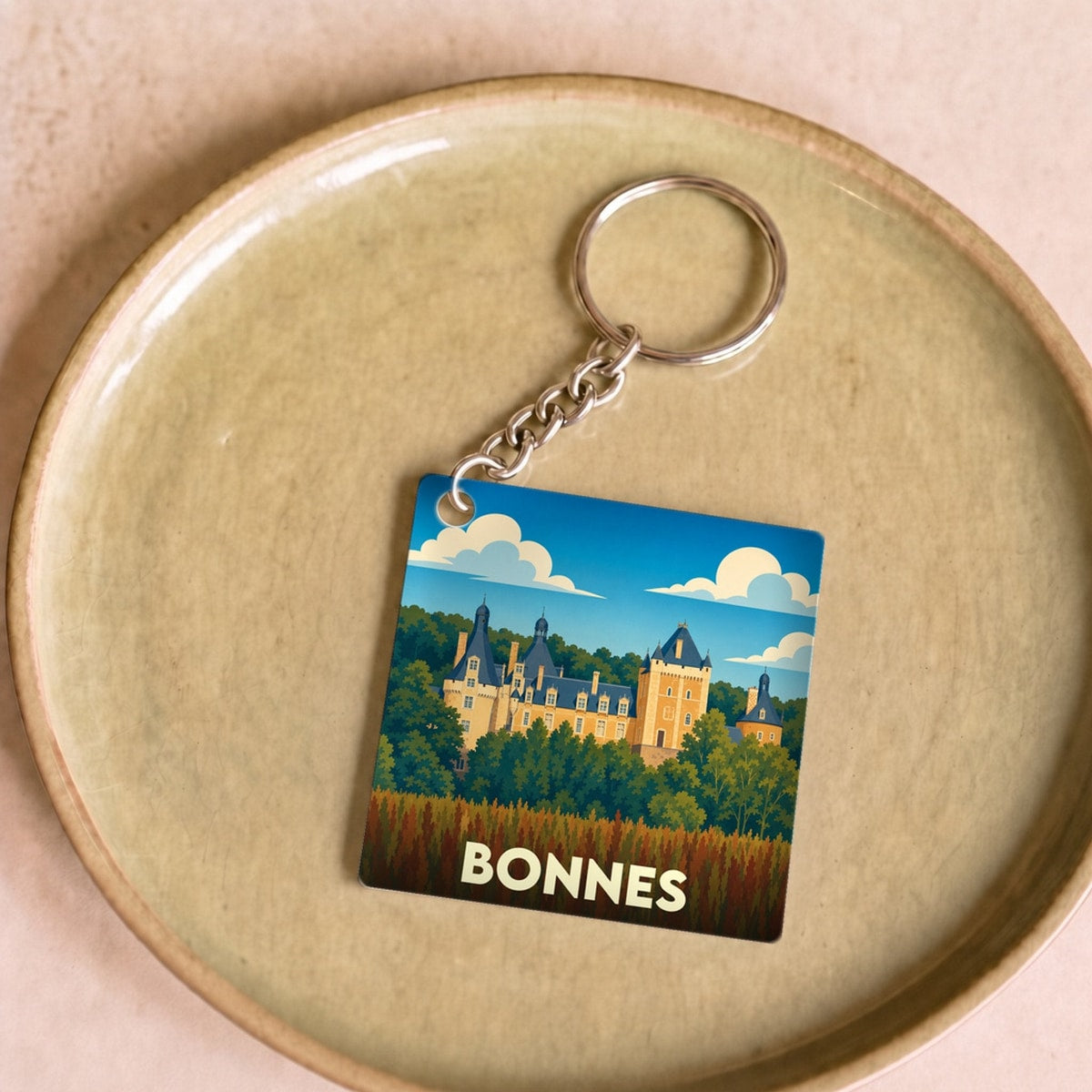 Porte-clés souvenir de la ville de Bonnes avec une illustration stylisée d'un château.