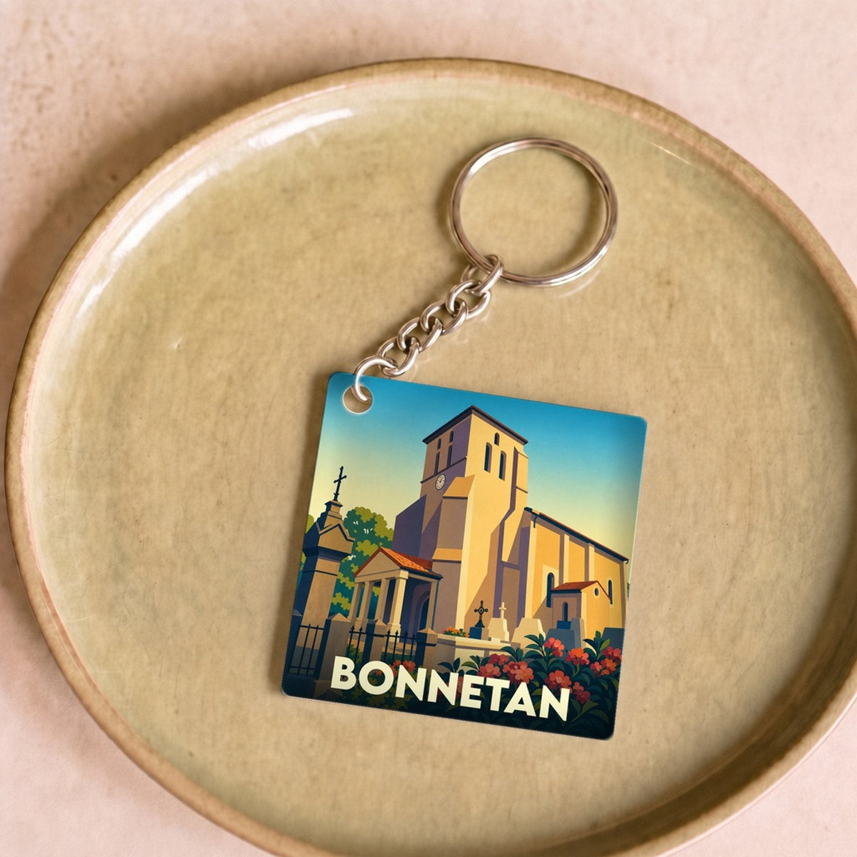 Porte-clés souvenir de la ville de Bonnetan avec une illustration stylisée de son église.