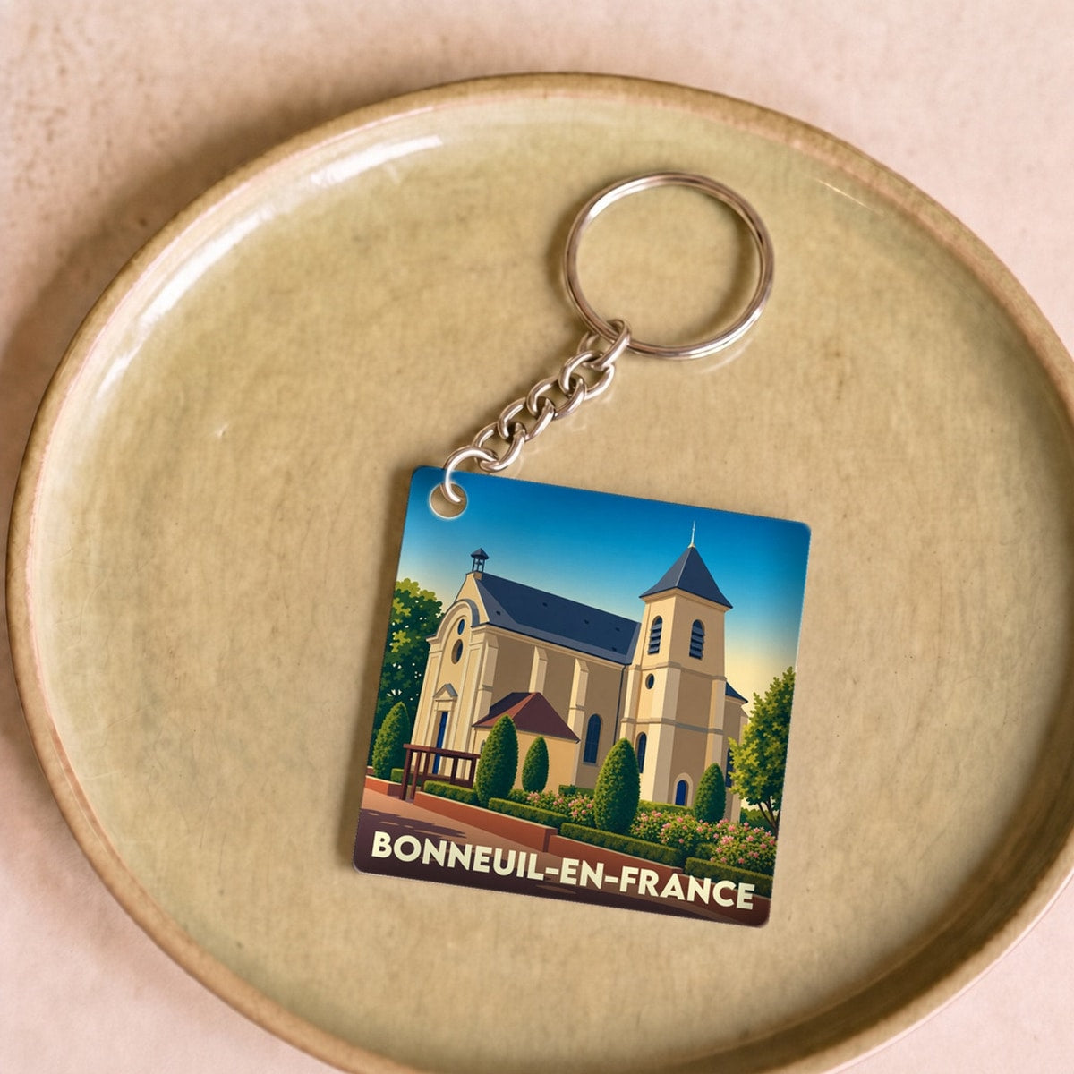 Porte-clés souvenir de la ville de Bonneuil-en-France avec une illustration stylisée de son église.