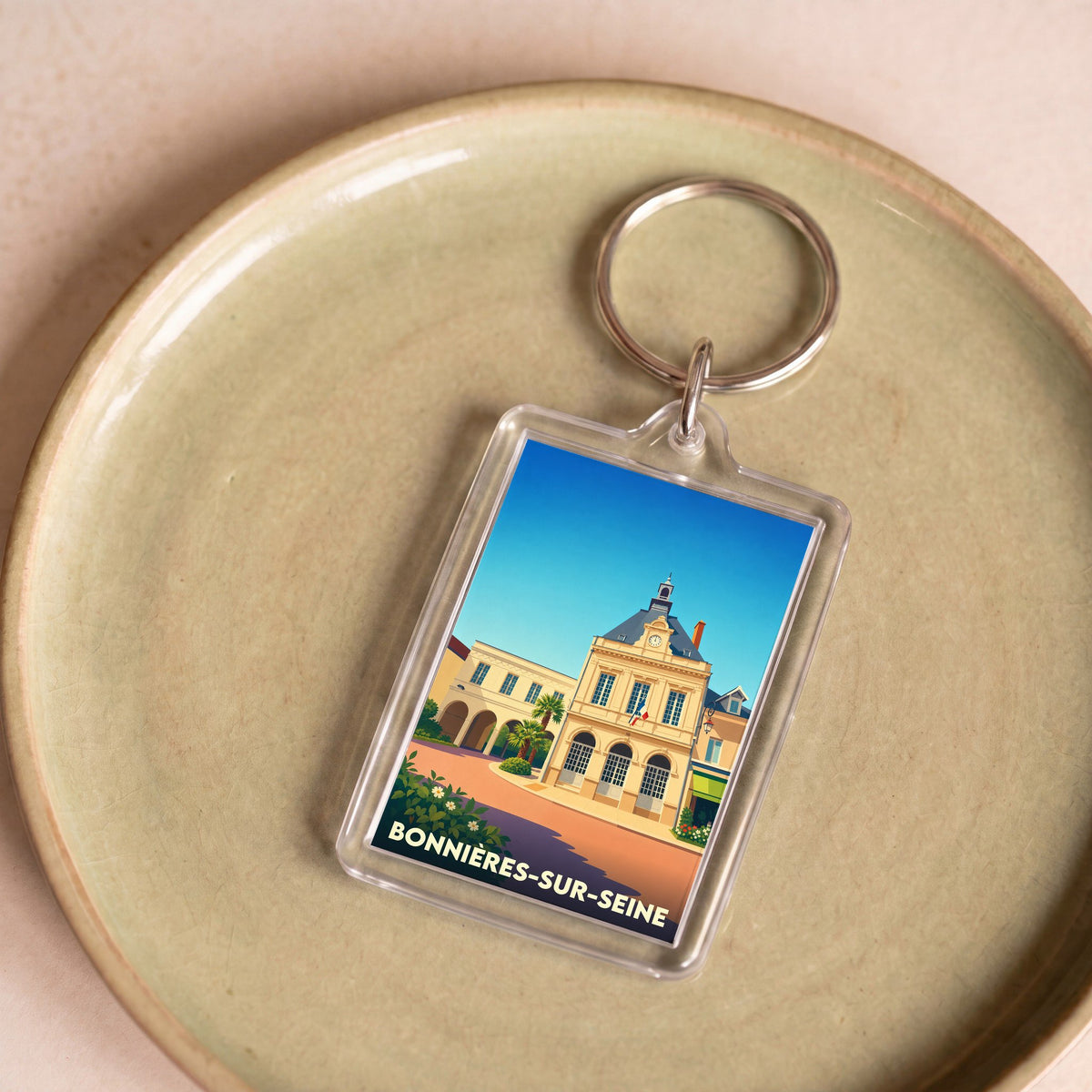 Porte-clés souvenir de la ville de Bonnières-sur-Seine avec une illustration stylisée de son hôtel de ville.