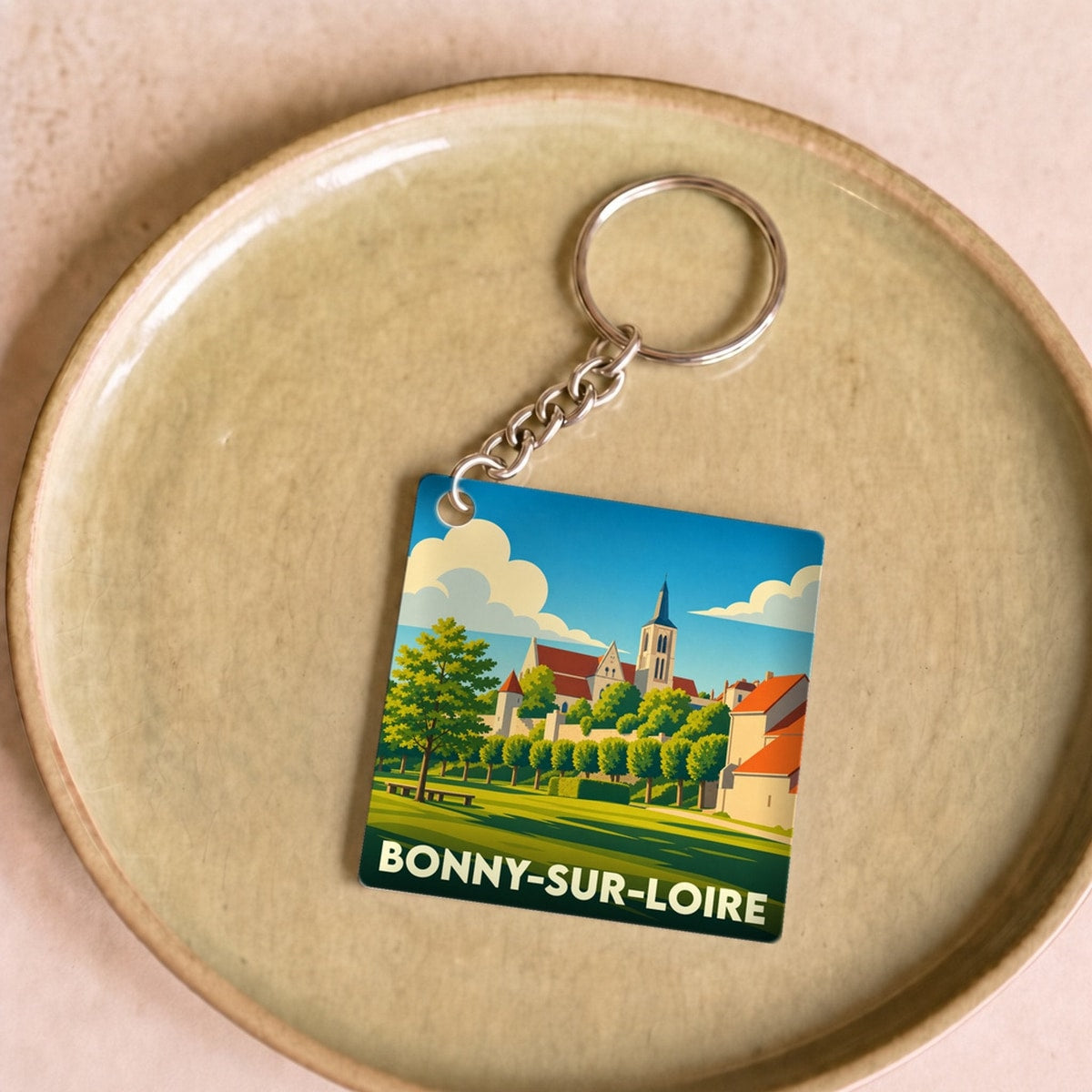 Porte-clés souvenir de la ville de Bonny-sur-Loire avec une illustration stylisée.