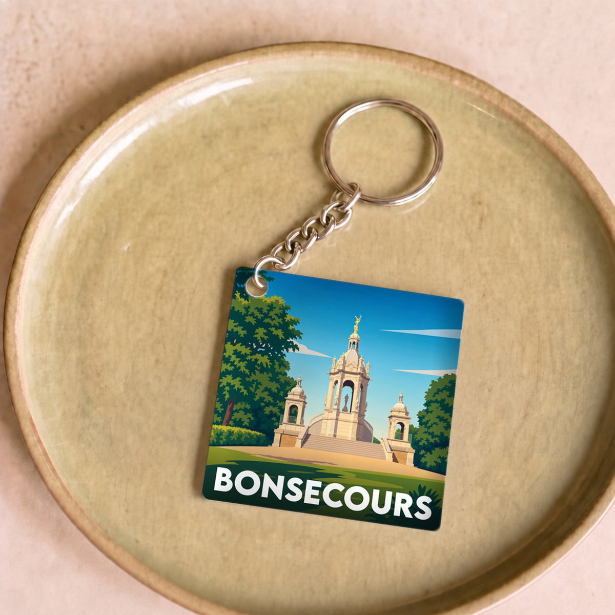 Porte-clés souvenir de la ville de Bonsecours avec une illustration stylisée d'un monument historique.
