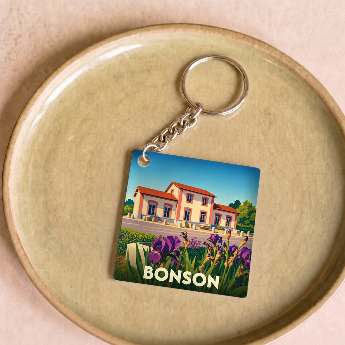Porte-clés souvenir de la ville de Bonson avec une illustration stylisée.