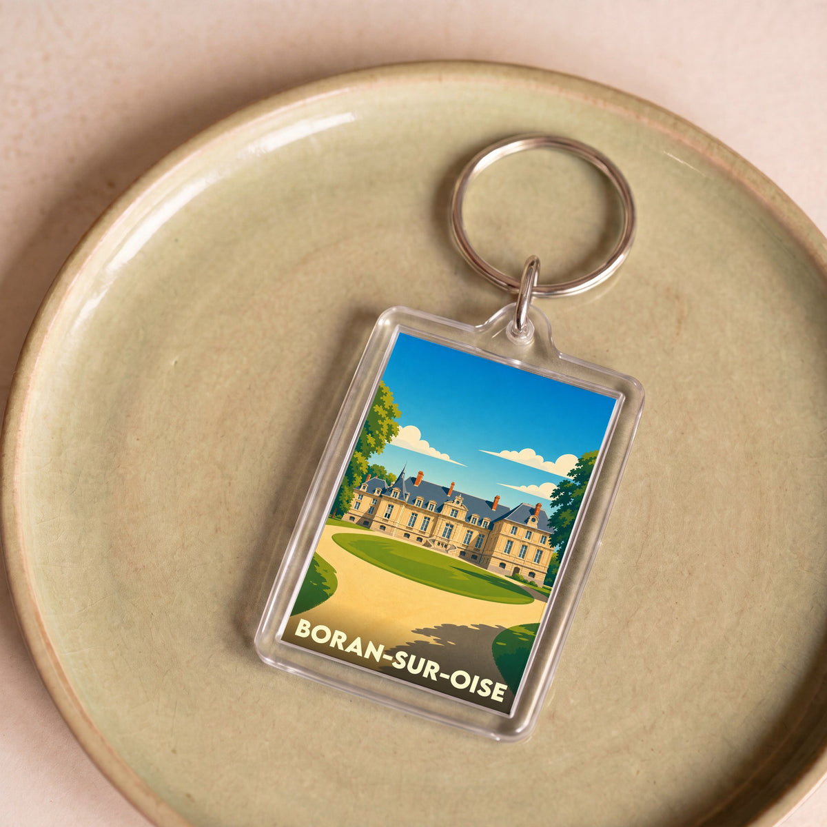 Porte-clés souvenir de la ville de Boran-sur-Oise avec une illustration stylisée de son château.