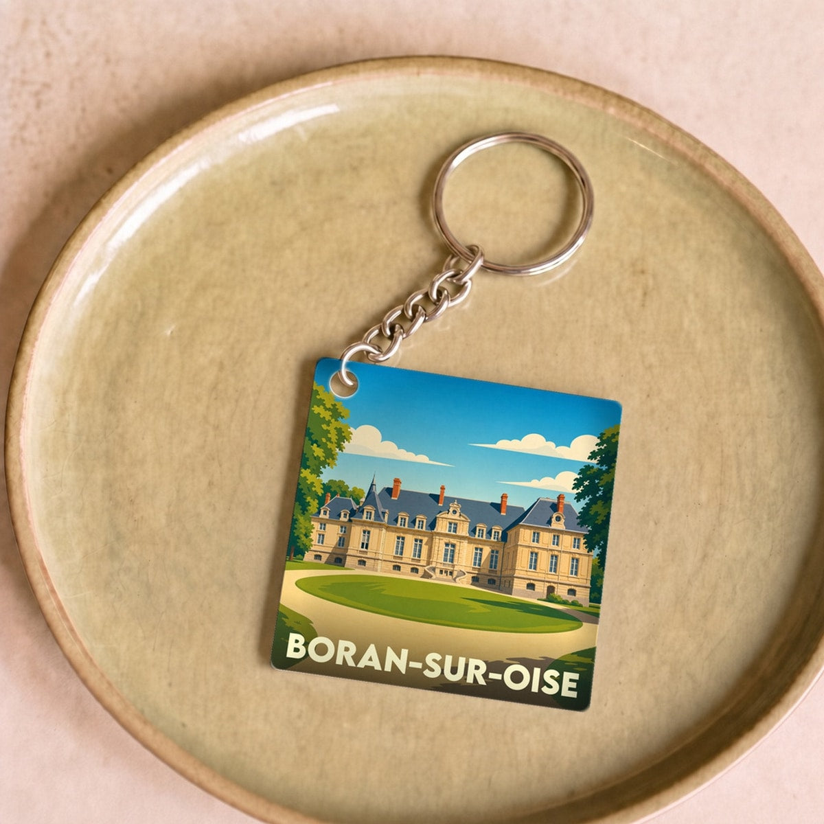 Porte-clés souvenir de la ville de Boran-sur-Oise avec une illustration stylisée de son château.
