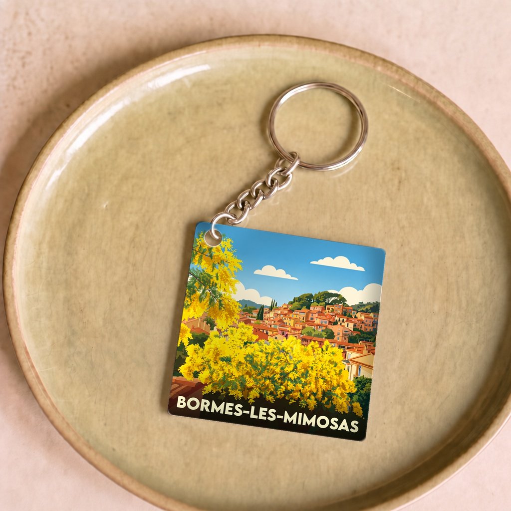 Porte-clés souvenir de la ville de Bormes-les-Mimosas avec une illustration stylisée.