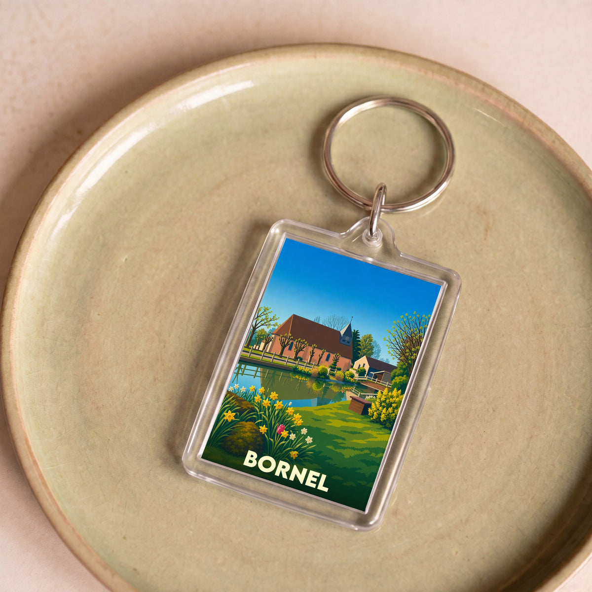 Porte-clés souvenir de la ville de Bornel avec une illustration stylisée et colorée.
