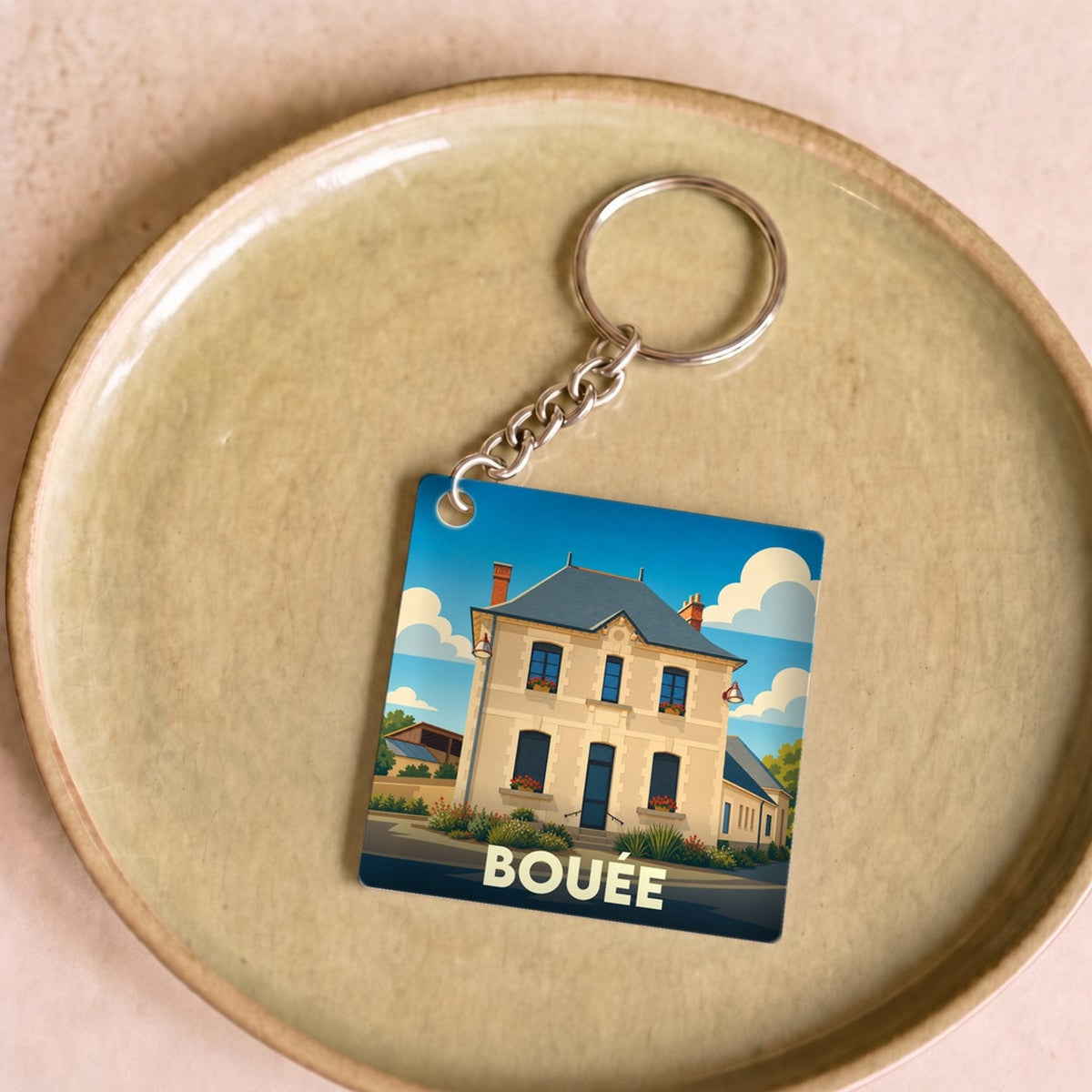 Porte-clés souvenir de la ville de Bouée avec une illustration stylisée.