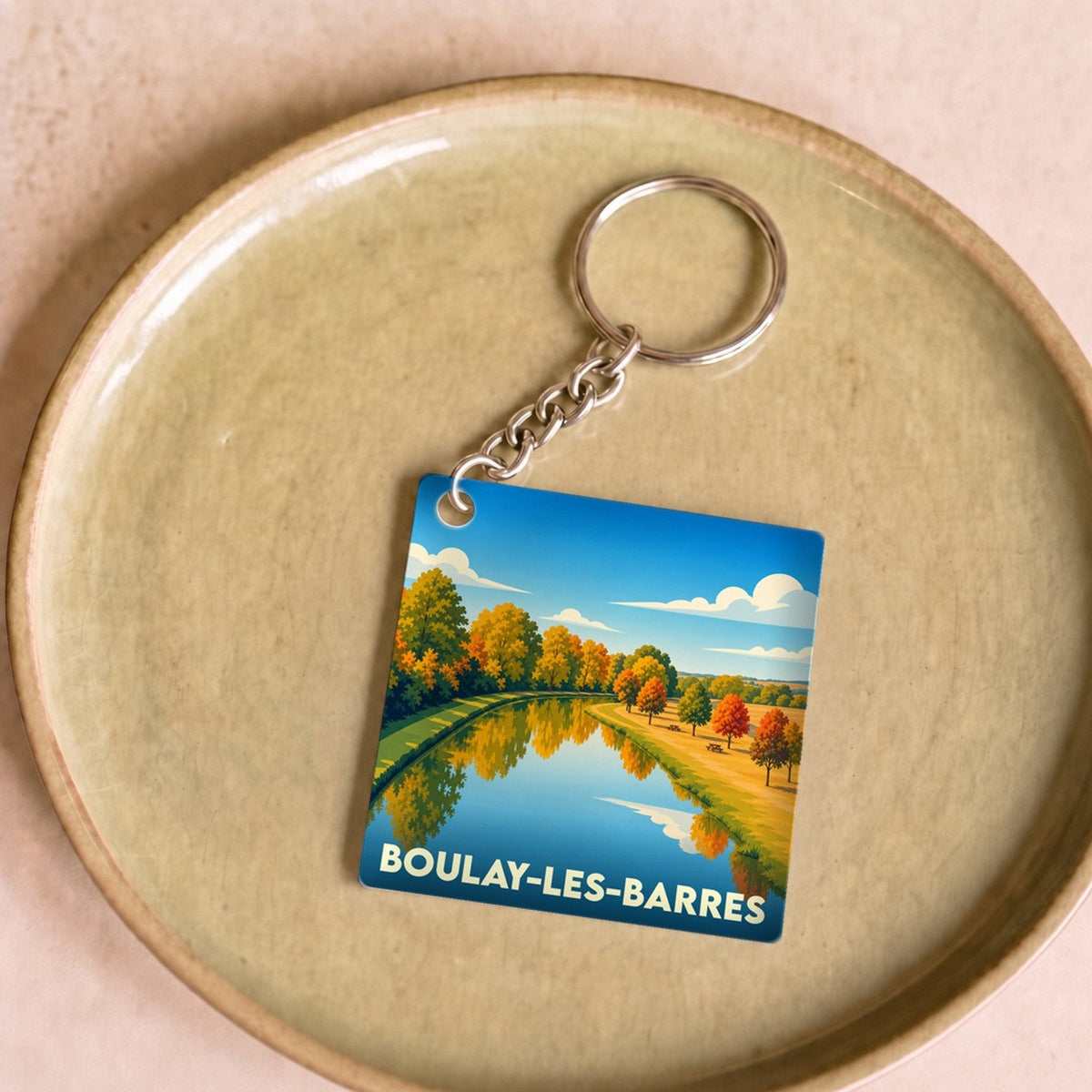 Porte-clés souvenir de la ville de Boulay-les-Barres avec une illustration automnale stylisée.