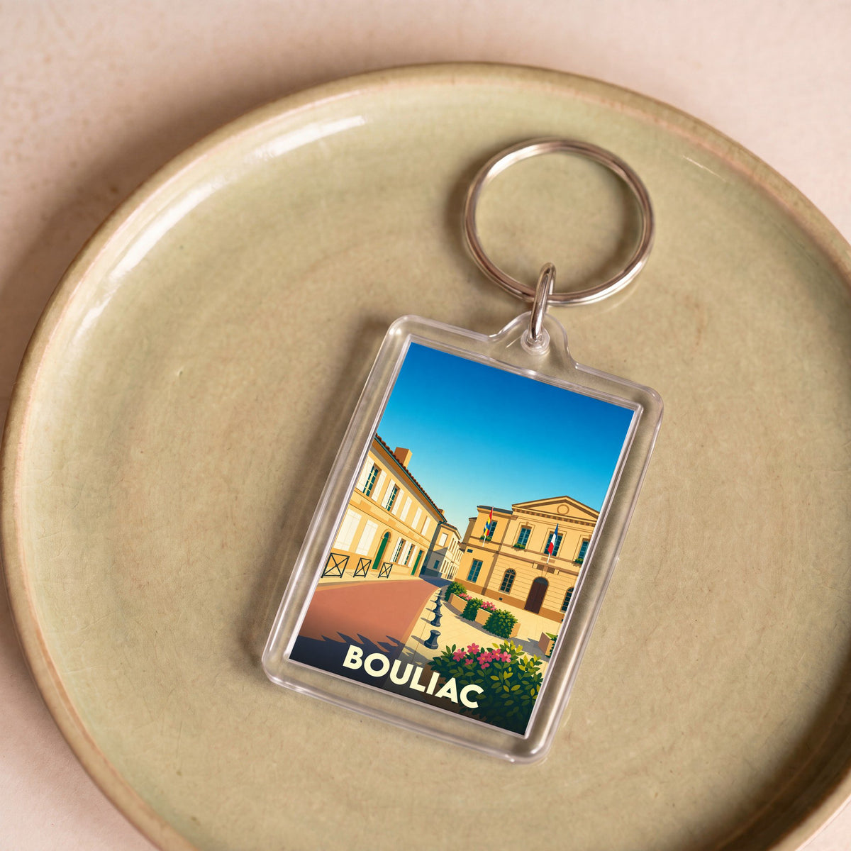 Porte-clés souvenir de la ville de Bouliac avec une illustration stylisée.