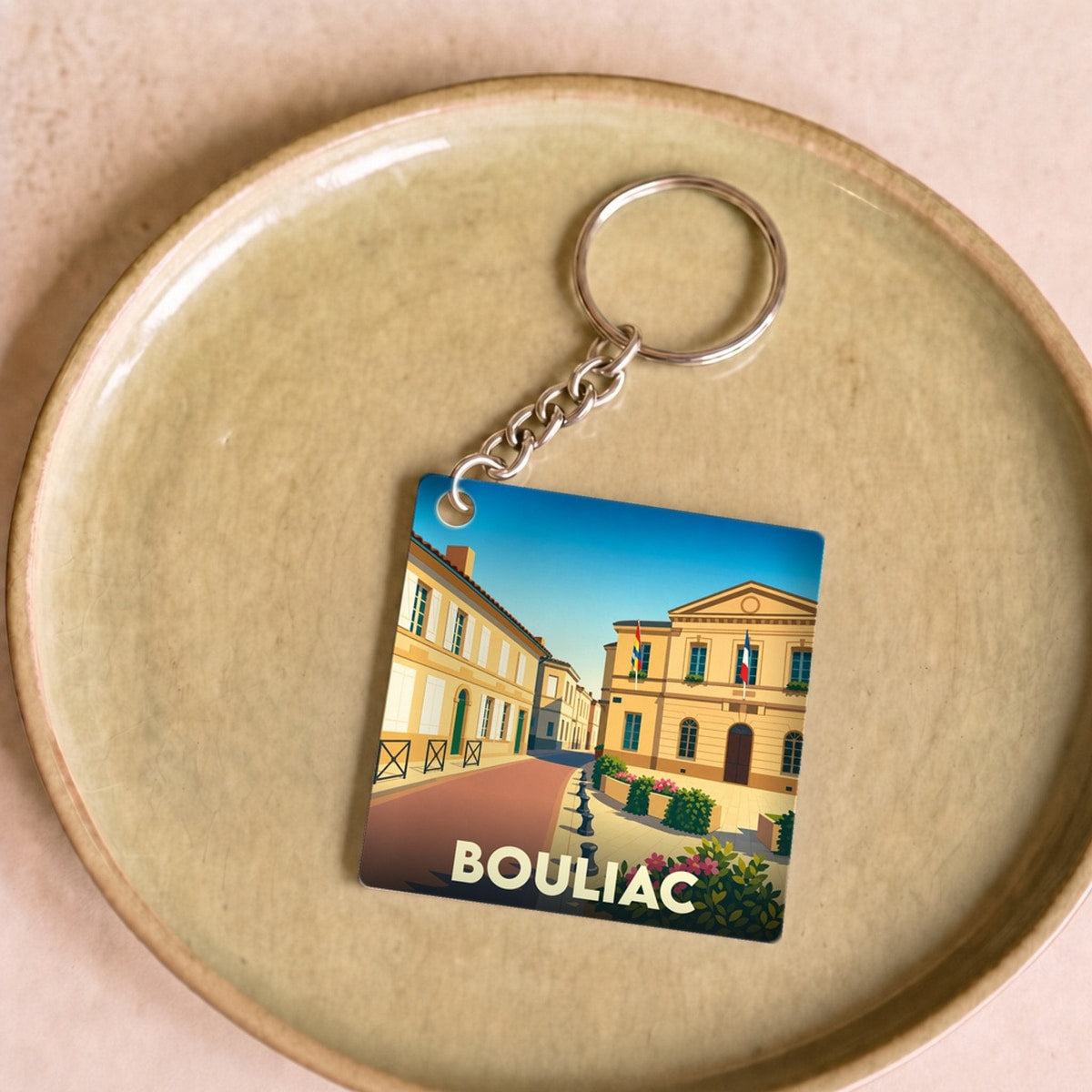 Porte-clés souvenir de la ville de Bouliac avec une illustration stylisée.