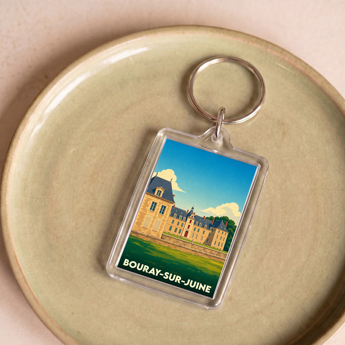 Porte-clés souvenir de la ville de Bouray-sur-Juine avec une illustration stylisée de son château.