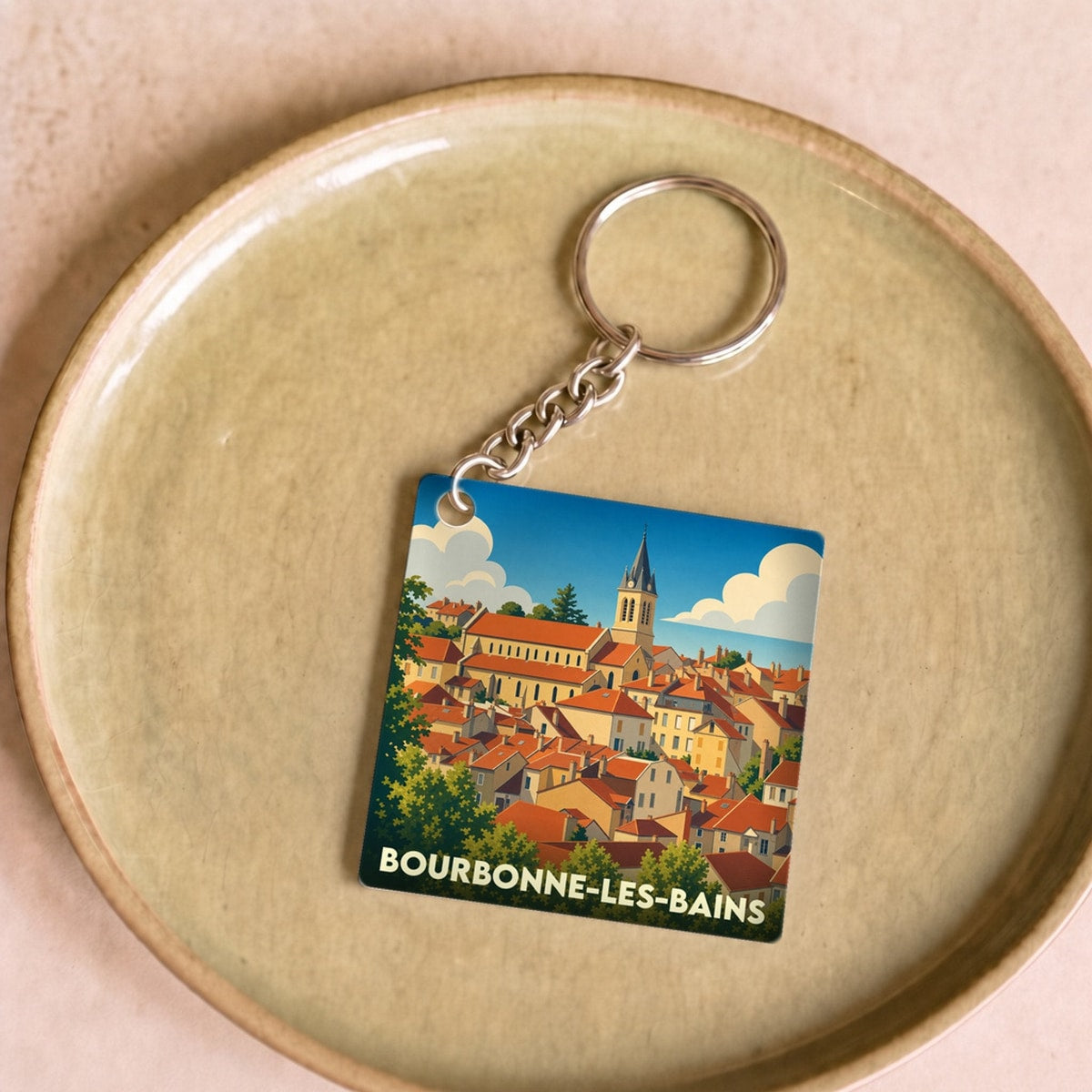 Porte-clés souvenir de la ville de Bourbonne-les-Bains avec une illustration stylisée.