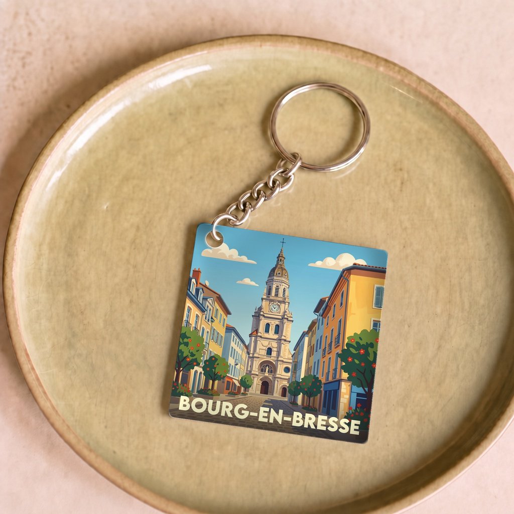 Porte-clés souvenir de la ville de Bourg-en-Bresse avec une illustration stylisée.
