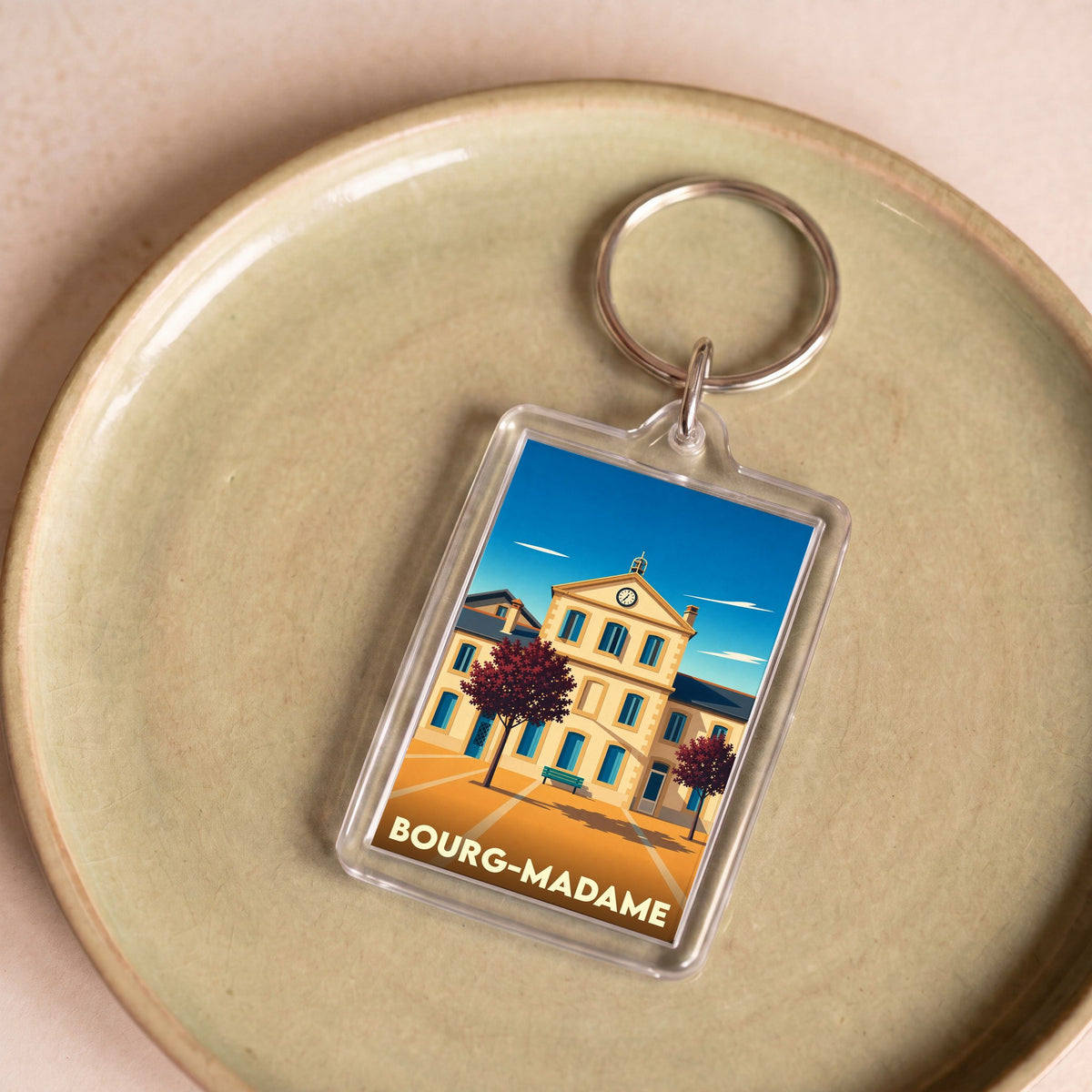 Porte-clés souvenir de la ville de Bourg-Madame avec une illustration stylisée.