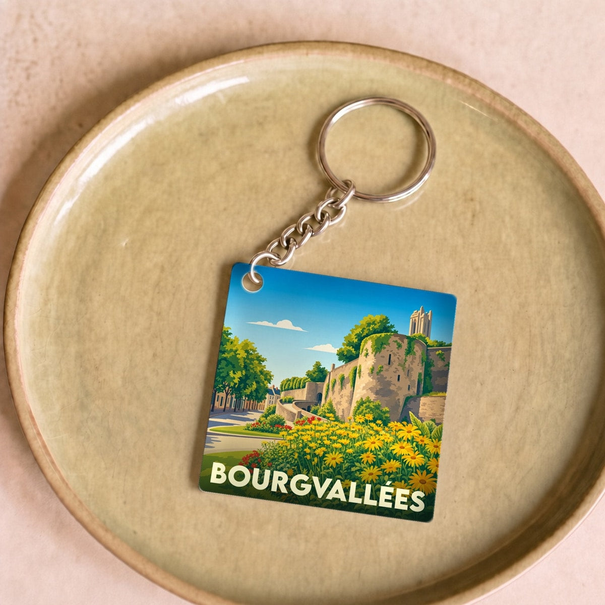 Porte-clés souvenir de la ville de Bourgvallées avec une illustration stylisée.