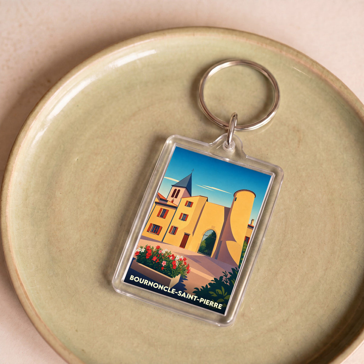 Porte-clés souvenir de la ville de Bournoncle-Saint-Pierre avec une illustration stylisée.