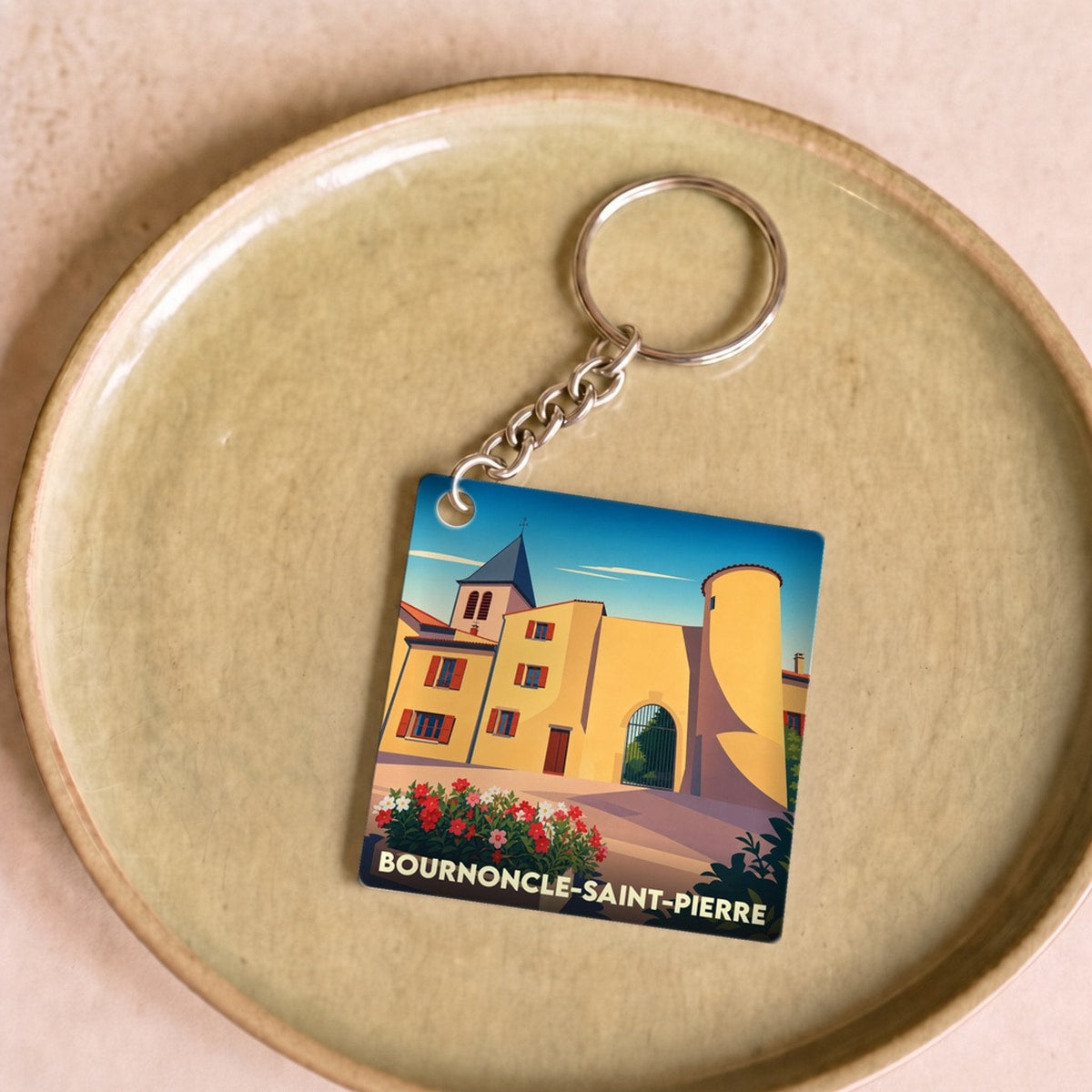 Porte-clés souvenir de la ville de Bournoncle-Saint-Pierre avec une illustration stylisée.