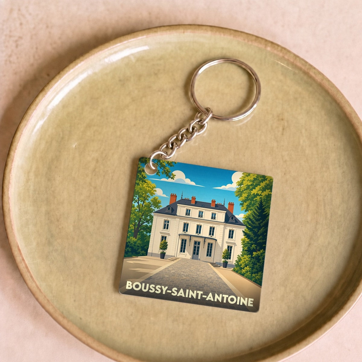 Porte-clés souvenir de la ville de Boussy-Saint-Antoine avec une illustration stylisée.