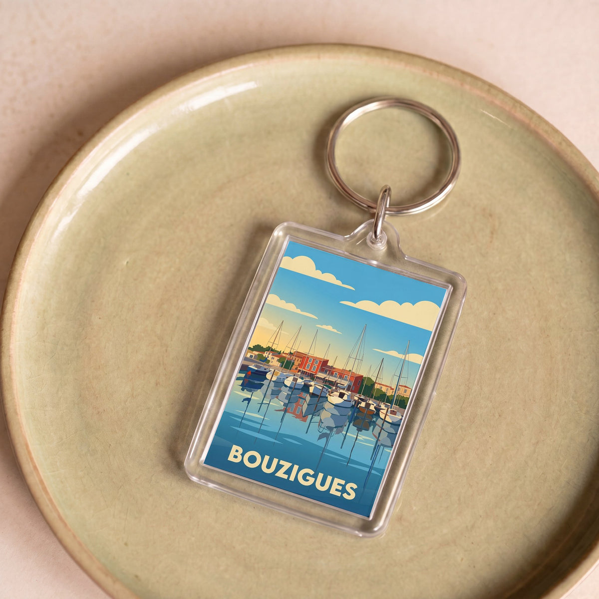 Porte-clés souvenir de la ville de Bouzigues avec une illustration stylisée de son port.