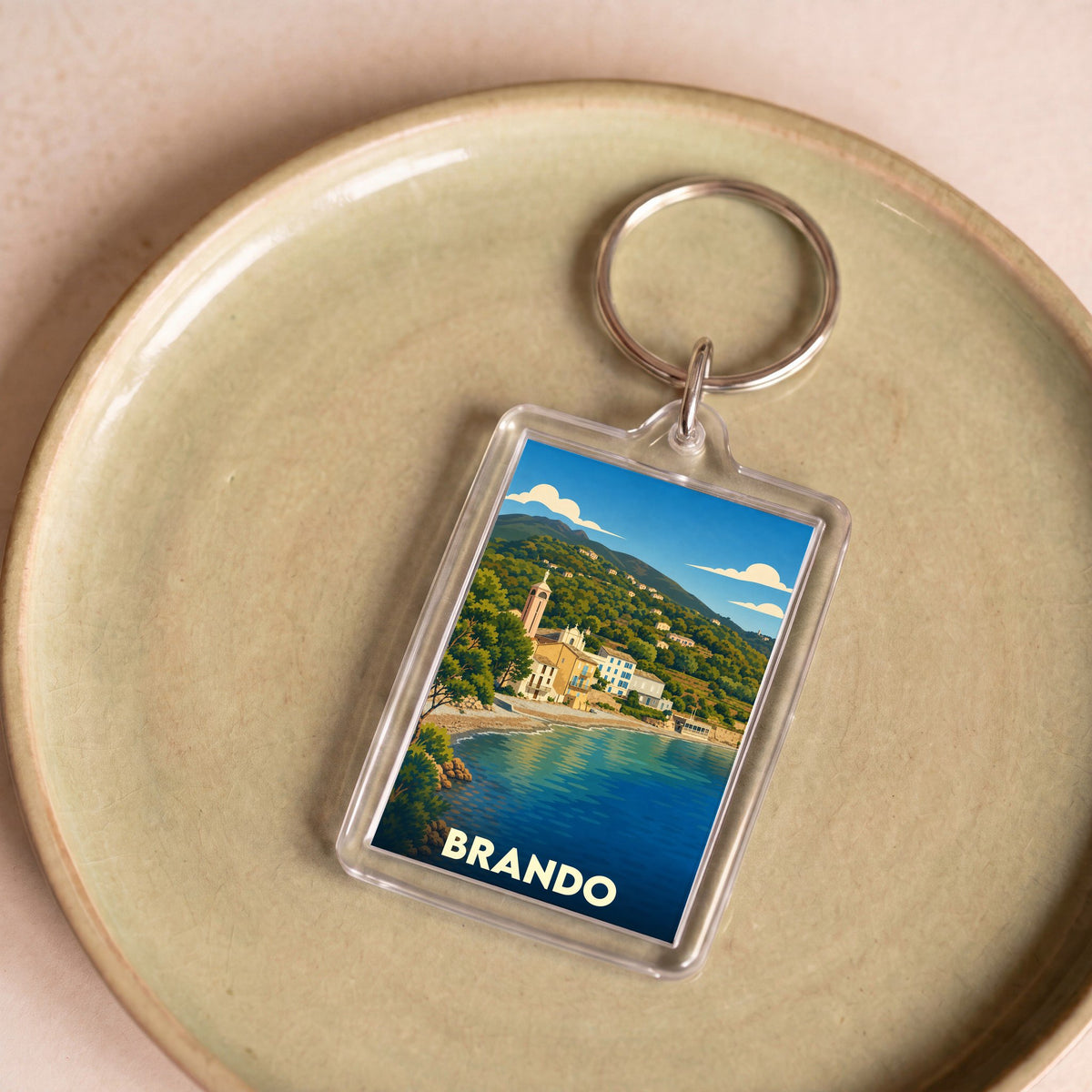 Porte-clés souvenir de la ville de Brando avec une illustration stylisée.