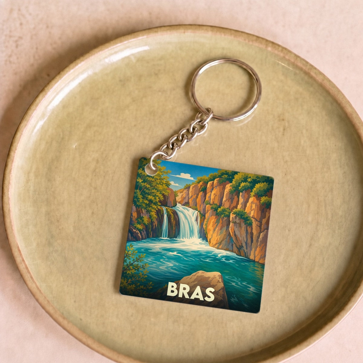Porte-clés souvenir de la ville de Bras avec une illustration stylisée d'une cascade.