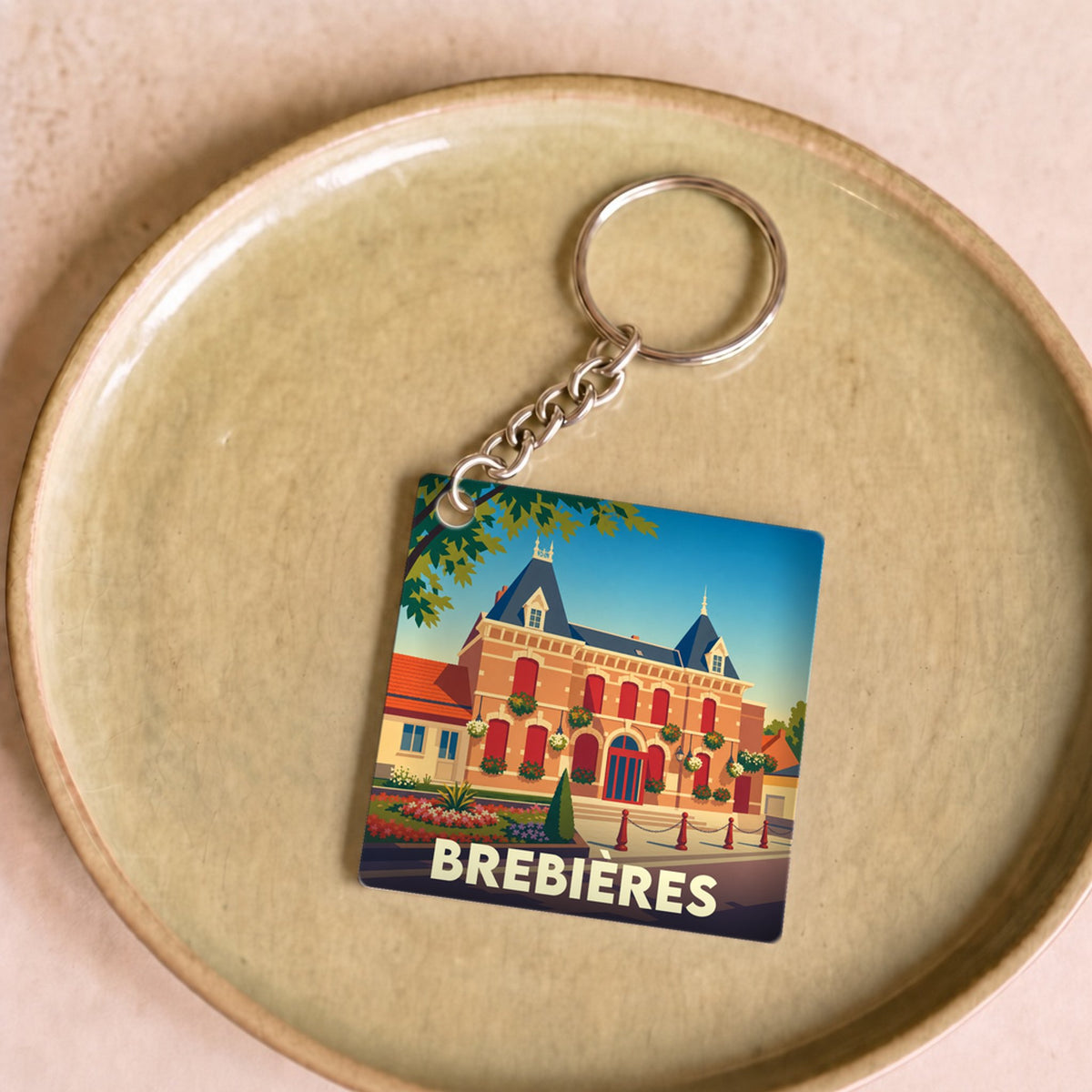 Porte-clés souvenir de la ville de Brebières avec une illustration stylisée de l'hôtel de ville.