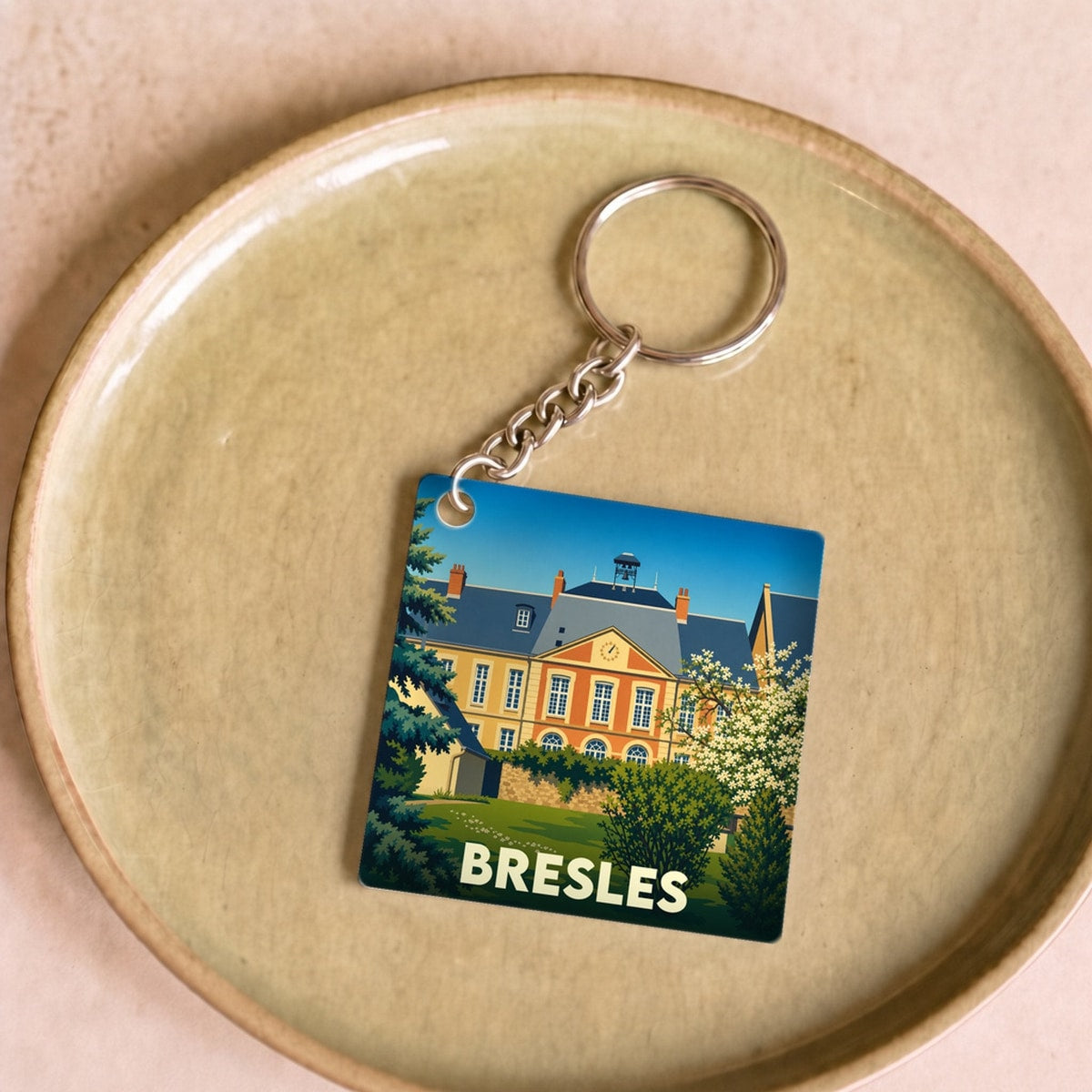 Porte-clés souvenir de la ville de Bresles avec une illustration stylisée de son château.