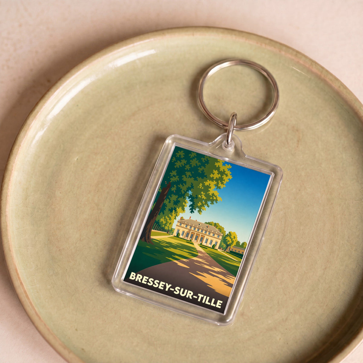 Porte-clés souvenir de la ville de Bressey-sur-Tille avec une illustration stylisée d'un château.
