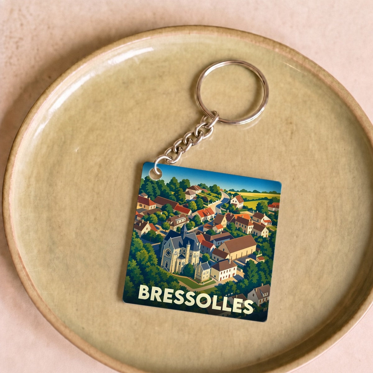 Porte-clés souvenir de la ville de Bressolles avec une illustration stylisée.