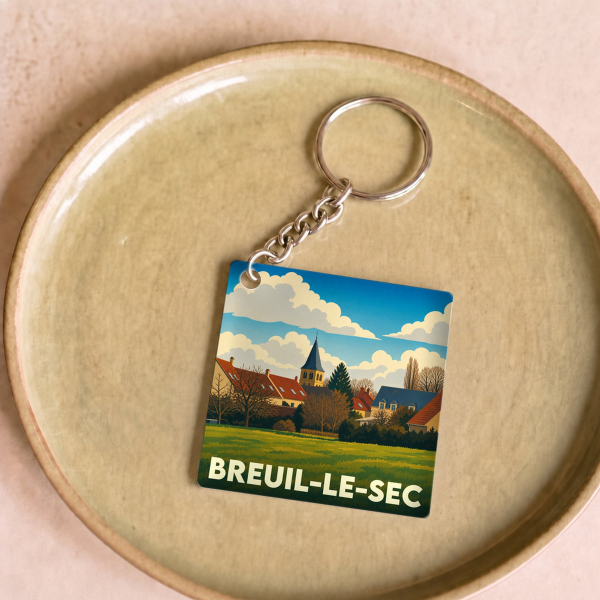 Porte-clés souvenir de la ville de Breuil-le-Sec avec une illustration stylisée.