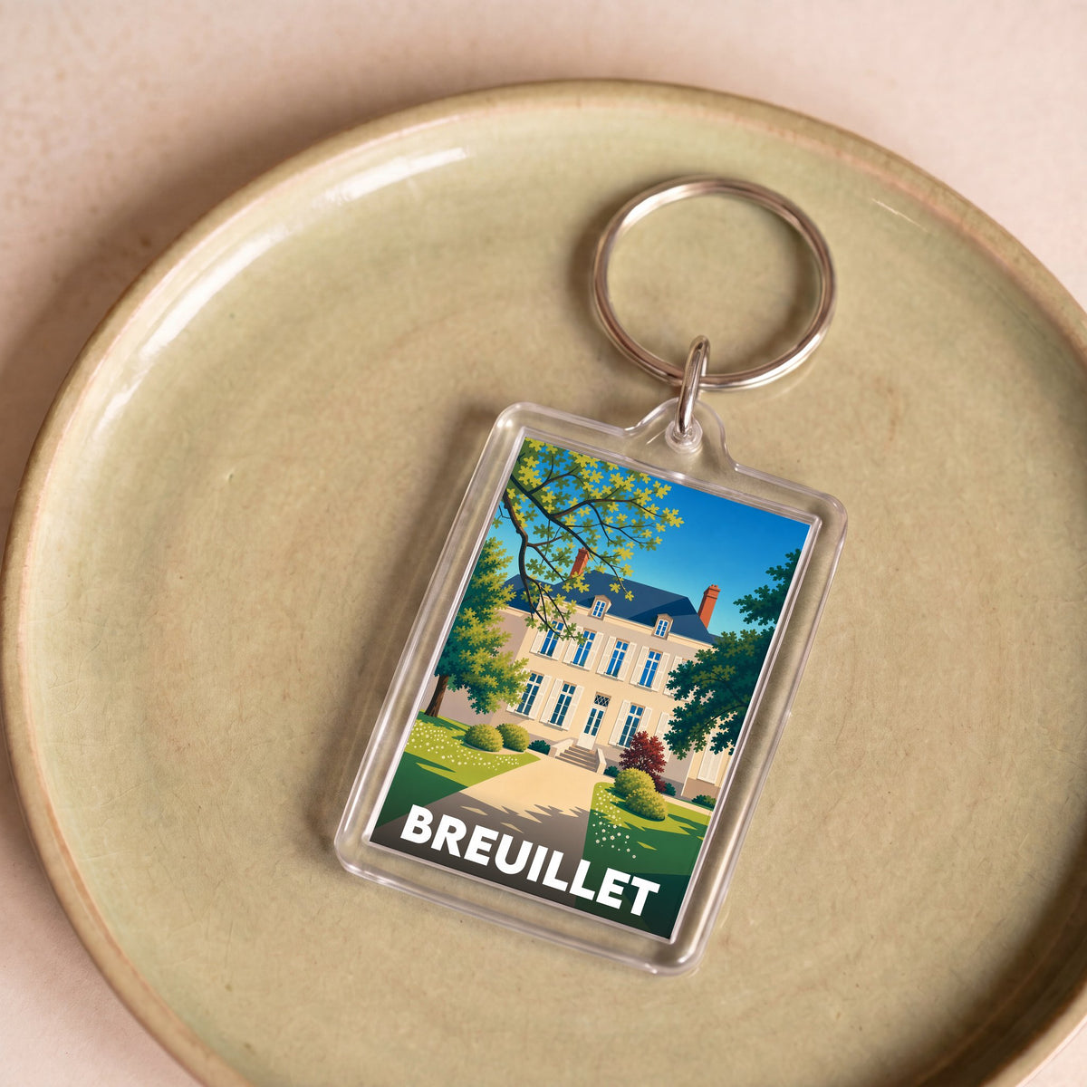 Porte-clés souvenir de la ville de Breuillet avec une illustration stylisée.